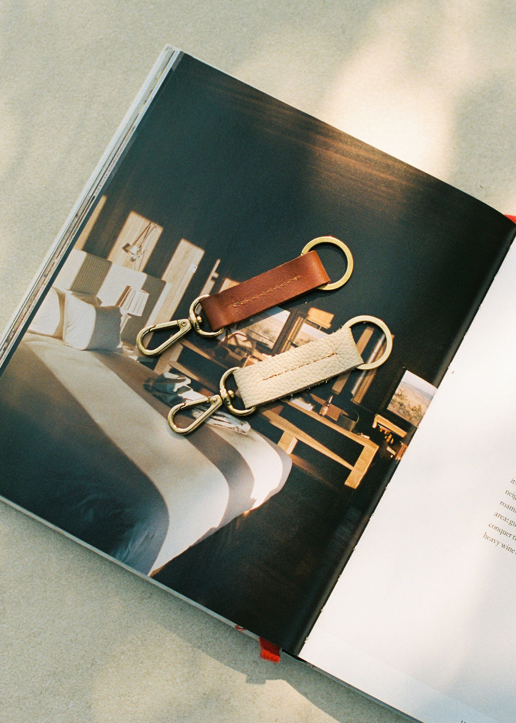 Keychains on an open book with a blurred interior background